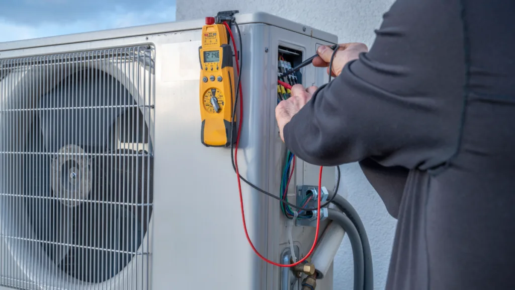 A technician installing a ductless mini split ac unit