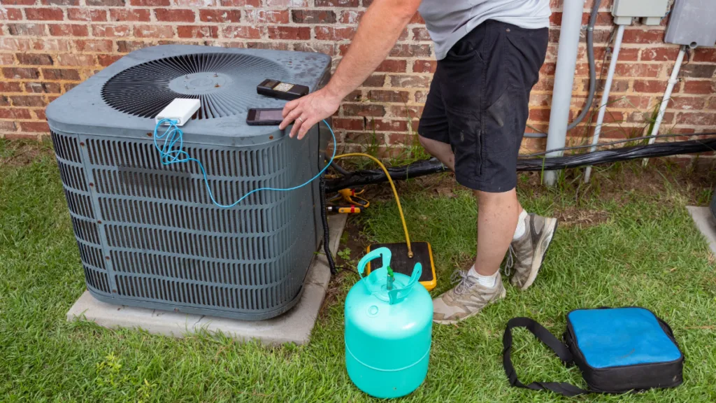 An ac technician charging an ac units refrigerant