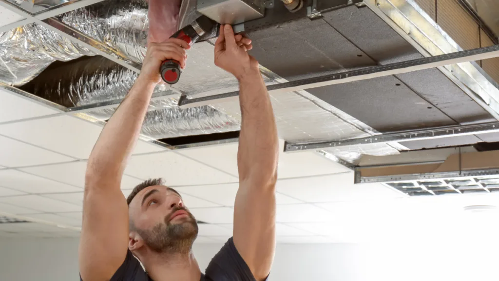 An hvac technician performing service on an advanced ventilation system
